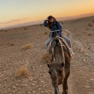 Kristian Derrick on a camel in the desert of North Africa.