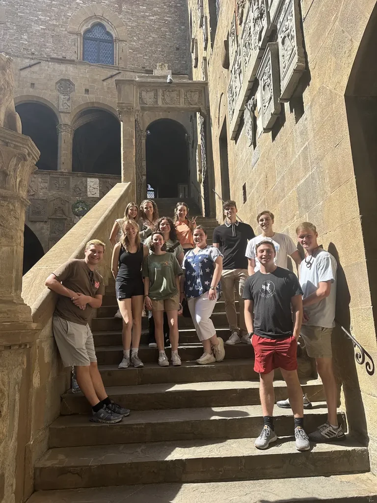 A group of UT students poses on the steps of the Bargello National Museum in Florence