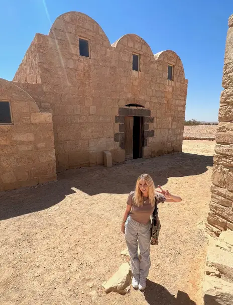 Boyd is seen standing in front of Qasr Amra, one of Jordan’s UNESCO world heritage sites.