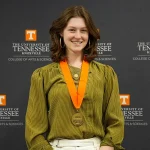 Emma Miller stands against a University of Tennessee backdrop at the ASURes Reception.